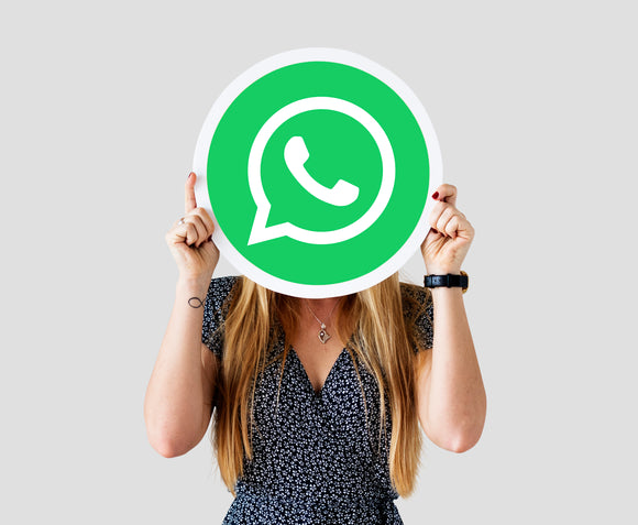 Woman showing whatsapp messenger icon